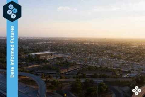 Photograph of Anaheim, CA from the sky with freeways and buildings in the background.