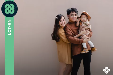 Picture of family holding their young child.
