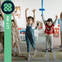 Photograph of 7 children dancing while in a preschool play area.