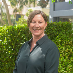 Portrait of Lisa Stanley, DrPH, Director of Data Informed Futures at the UCLA Center for Healthier Children, Families & Communities, standing in front of some greenery.